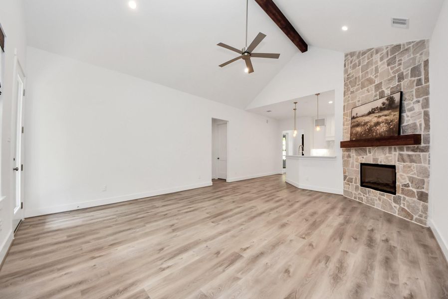 Another view of the living room featuring a seamless connection to the kitchen and dining areas.