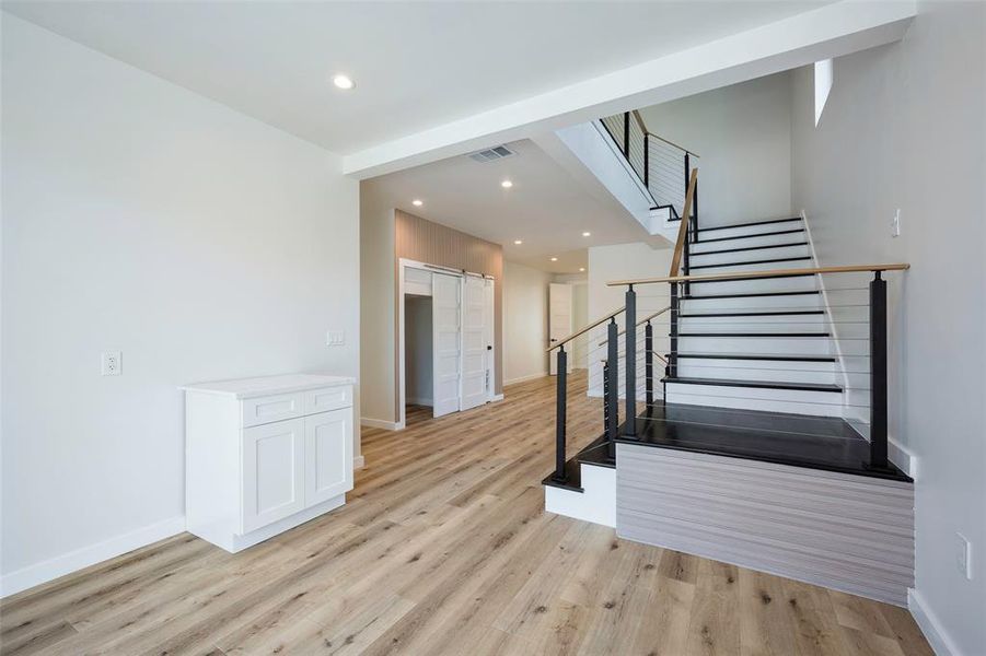 Staircase with wood flooring up to the rooftop third floor