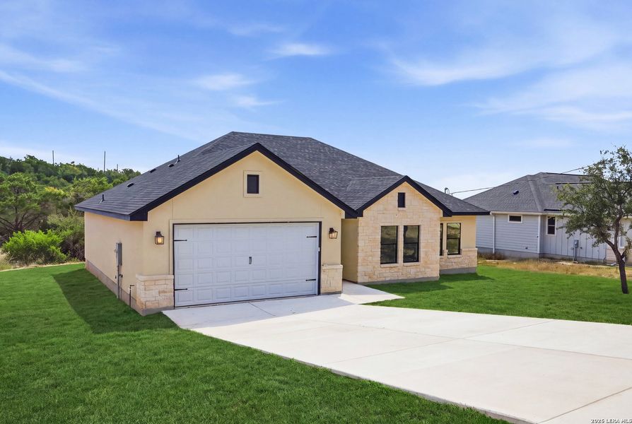 Front exterior of a new home in , Fischer, TX, highlighting curb appeal (Image 27). Front exterior of a new home in , Fischer, TX, highlighting curb appeal (Image 27).