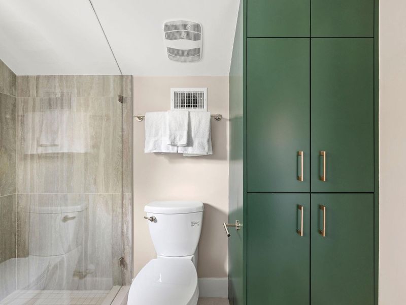 Full bathroom with a stall shower and toilet