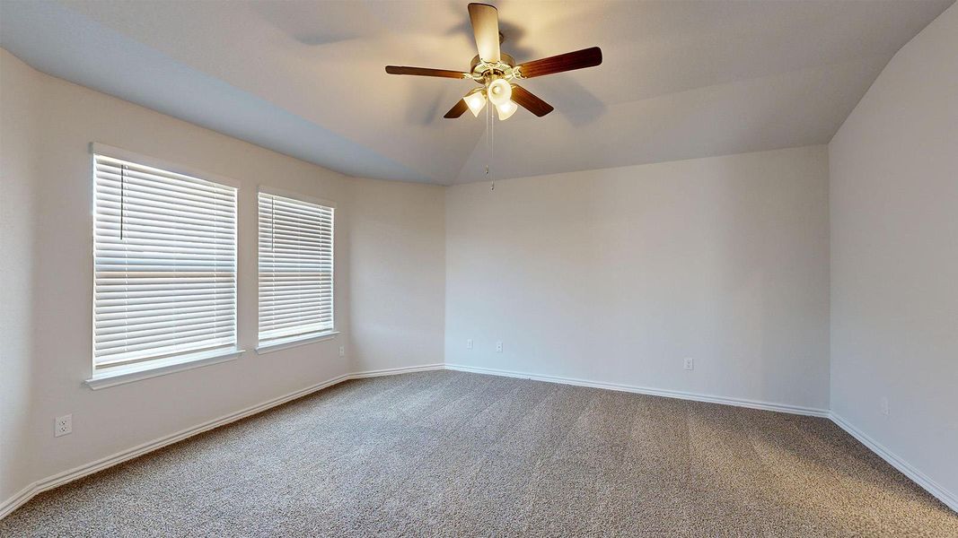 Unfurnished room featuring ceiling fan, light carpet, and vaulted ceiling Unfurnished room featuring ceiling fan, light carpet, and vaulted ceiling