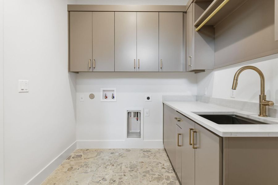 Washroom with electric dryer hookup, washer hookup, gas dryer hookup, and cabinet space