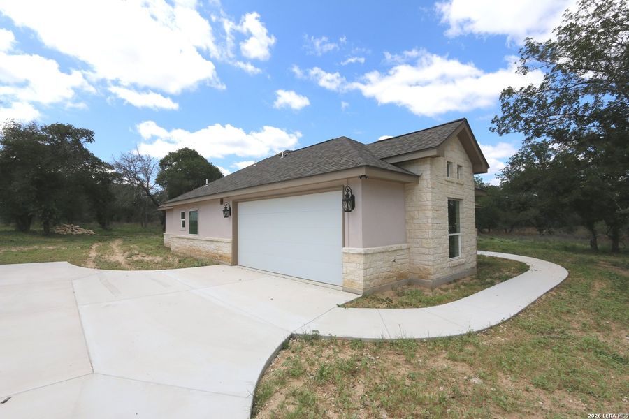 Front exterior of a new home in , Floresville, TX, highlighting curb appeal (Image 27).