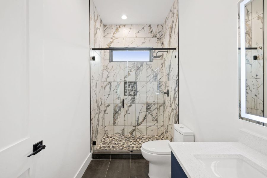 Modern bathroom with floor-to-ceiling ceramic tiles