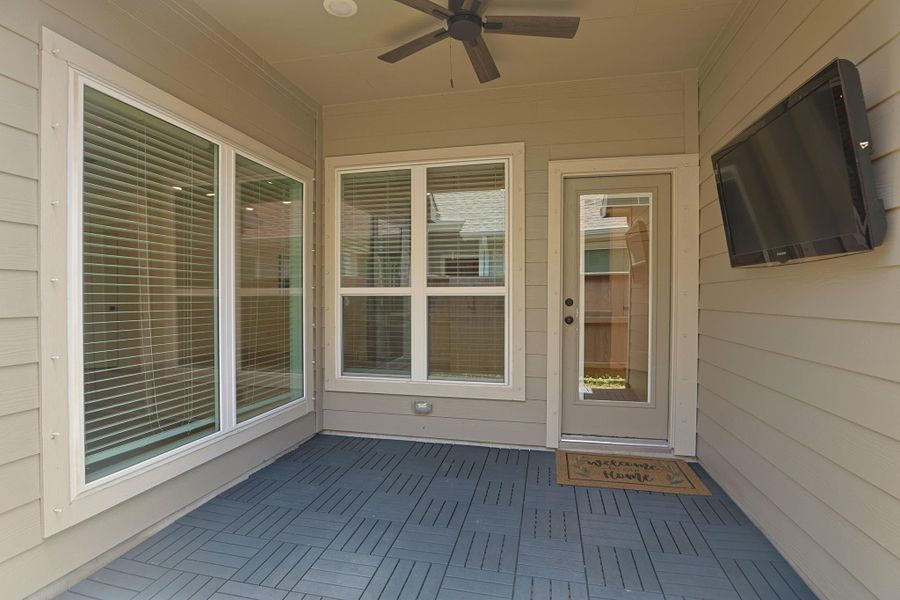 Relax and unwind on the covered backyard patio complete with a TV creating the perfect outdoor retreat!