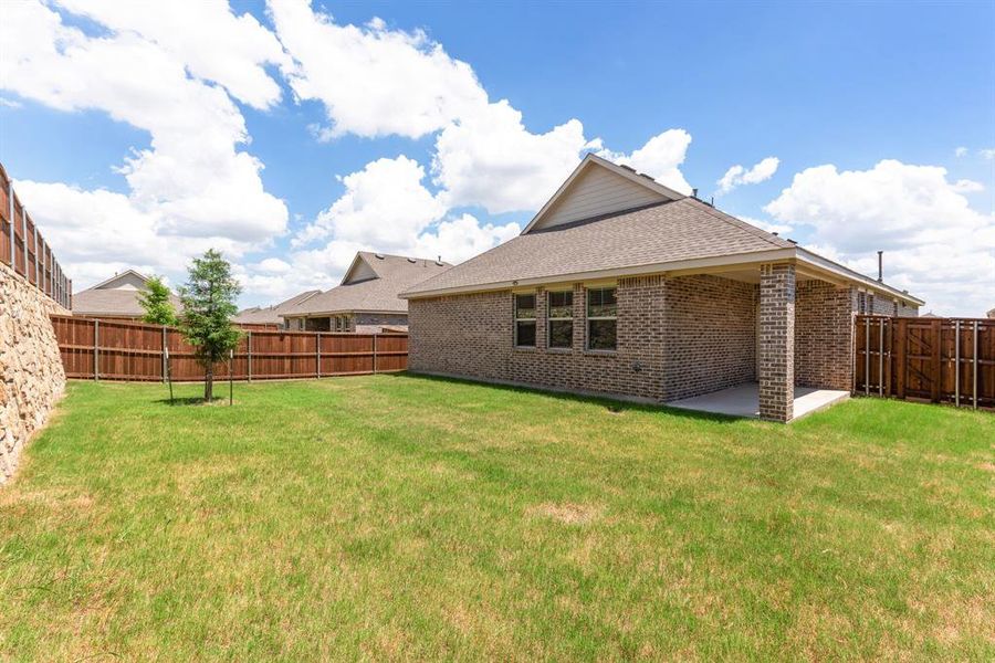 Huge flat backyard with lots of privacy. Hardscape of wall would make great landscape background. Plenty of room for trampoline,  garden and more.