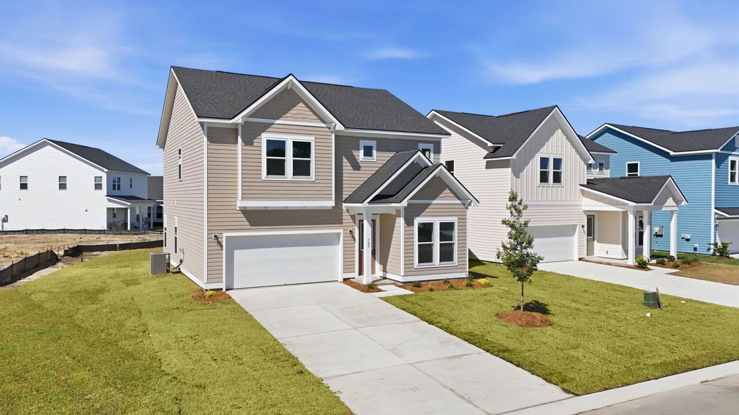 Front exterior of a new home in Blue Heron Retreat, Little River, SC, highlighting curb appeal (Image 2). Front exterior of a new home in Blue Heron Retreat, Little River, SC, highlighting curb appeal (Image 2).