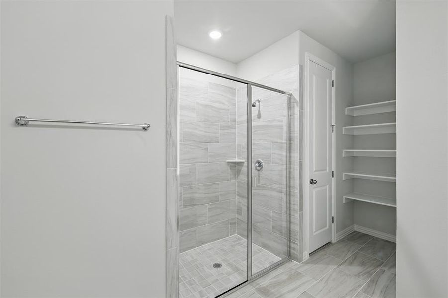 Bathroom with a stall shower and baseboards