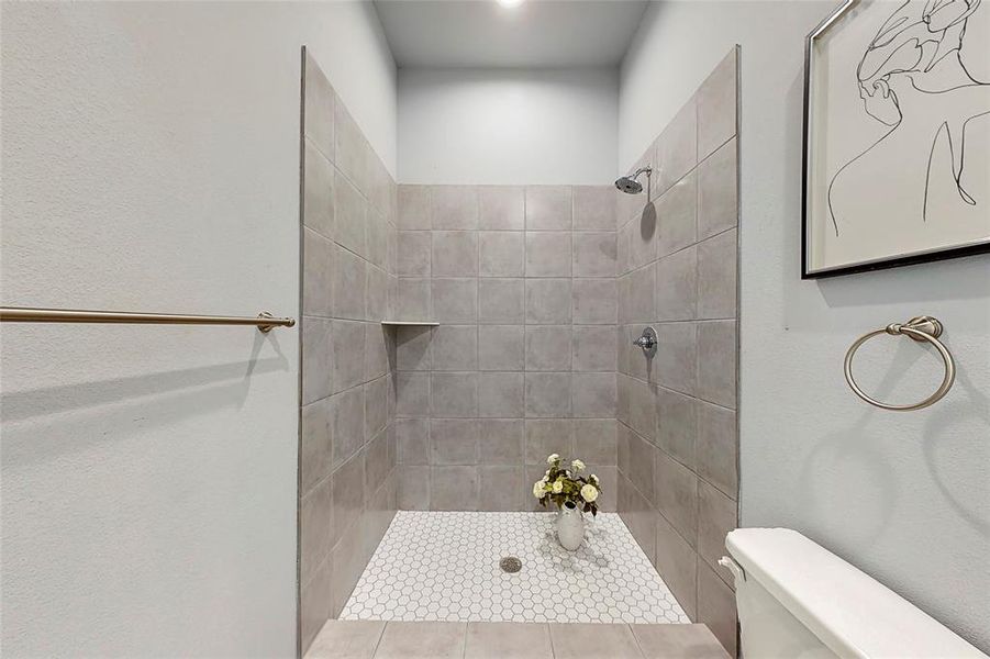 secondary bathroom with a shower/ tub and a water closet