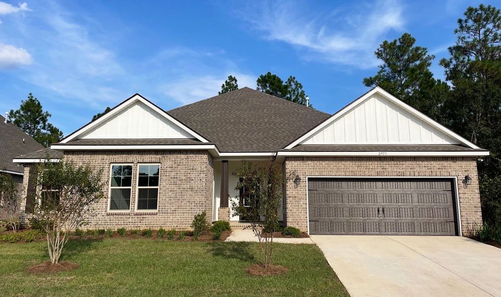 Front exterior of a new home in Iron Rock, Cantonment, FL, highlighting curb appeal (Image 1). Front exterior of a new home in Iron Rock, Cantonment, FL, highlighting curb appeal (Image 1).