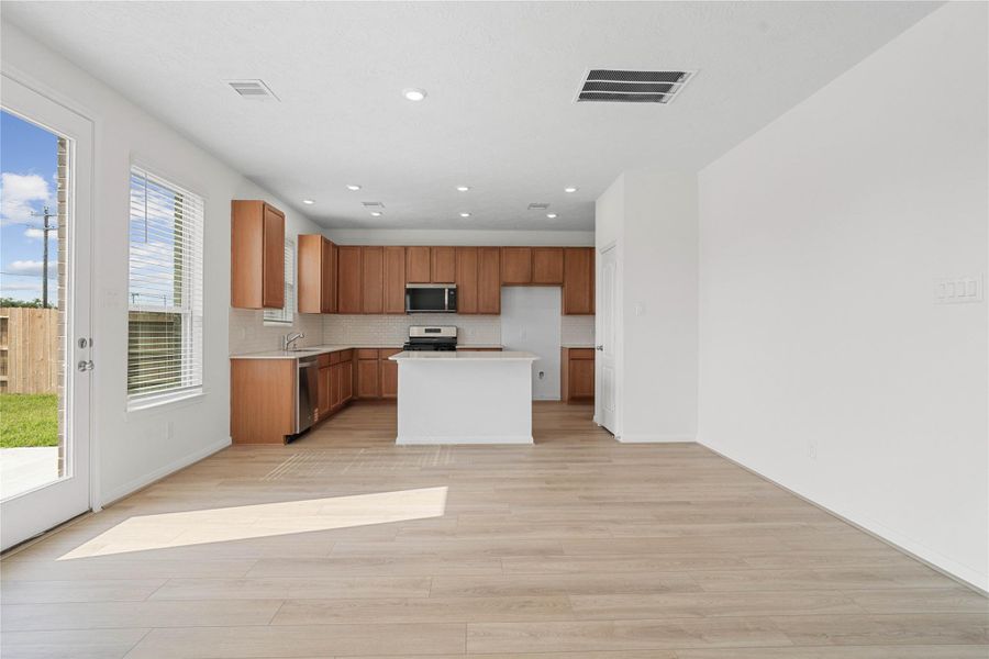Create lasting memories around the table with family and friends in this inviting dining room! It showcases high ceilings, large windows with privacy blinds, and recessed lighting, and access door to the back patio and yard. Create lasting memories around the table with family and friends in this inviting dining room! It showcases high ceilings, large windows with privacy blinds, and recessed lighting, and access door to the back patio and yard.