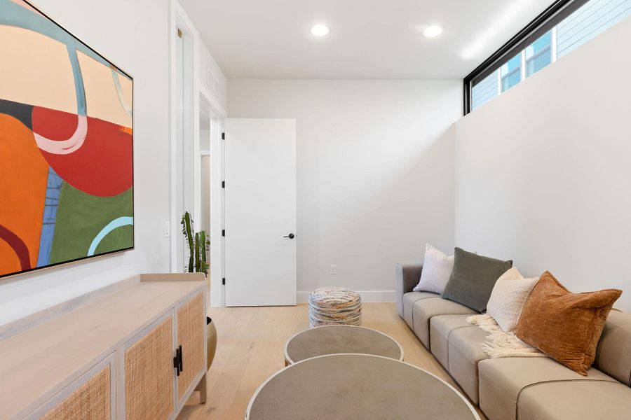 Living room featuring recessed lighting, baseboards, and light wood-style floors