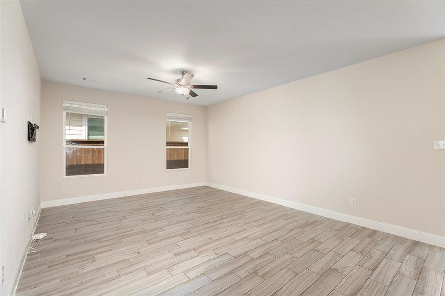 Unfurnished room with a ceiling fan and light wood-style floors