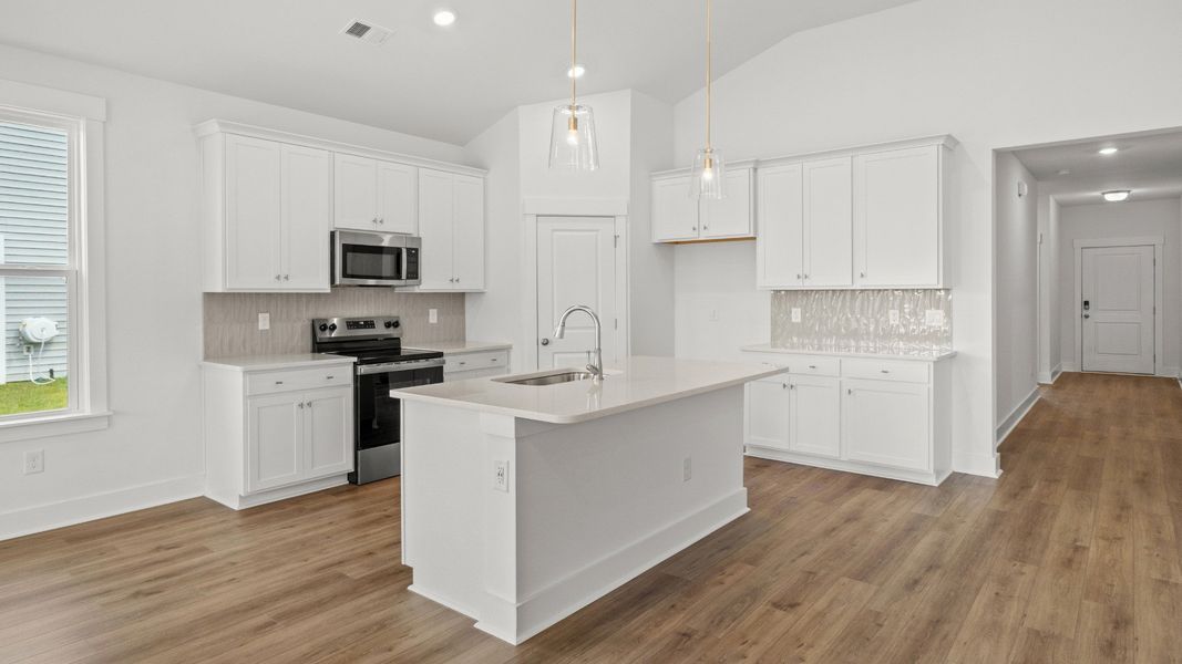 Elegant kitchen with quartz countertops, island seating, and Craftsman detail. Elegant kitchen with quartz countertops, island seating, and Craftsman detail.