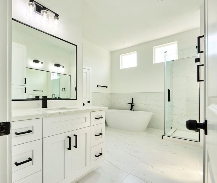 Designed for comfort and convenience, the primary bathroom features double sinks with sleek, modern fixtures. The spacious vanity area offers ample storage, making it a perfect blend of style and function. Designed for comfort and convenience, the primary bathroom features double sinks with sleek, modern fixtures. The spacious vanity area offers ample storage, making it a perfect blend of style and function.