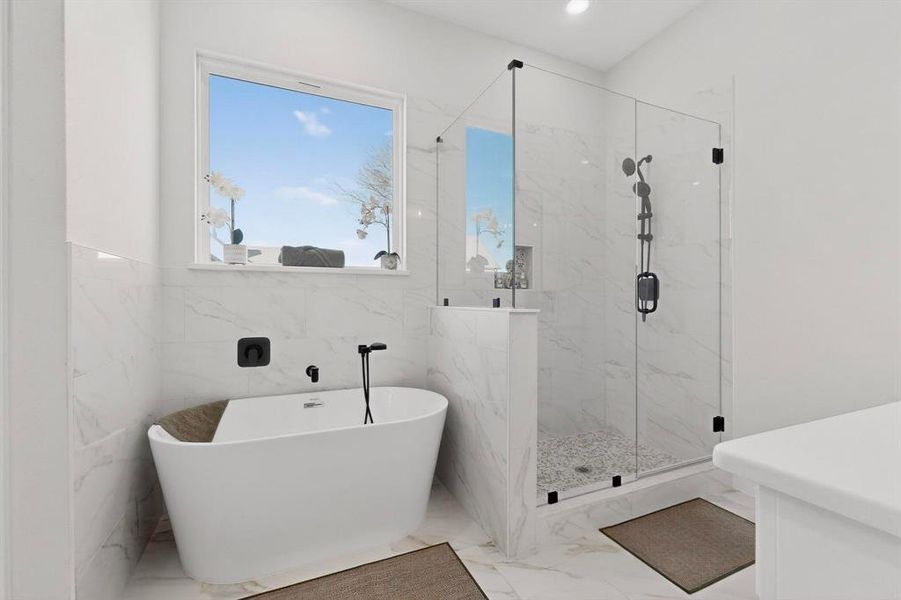 Full bathroom featuring a marble finish shower, a freestanding bath, light marble finish floors, recessed lighting, and vanity