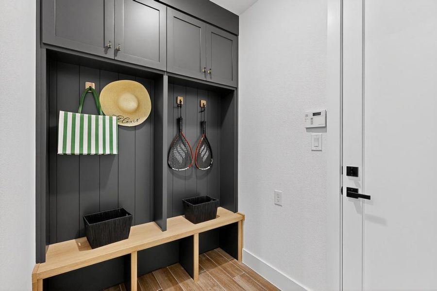 Mudroom featuring light wood-type flooring and baseboards