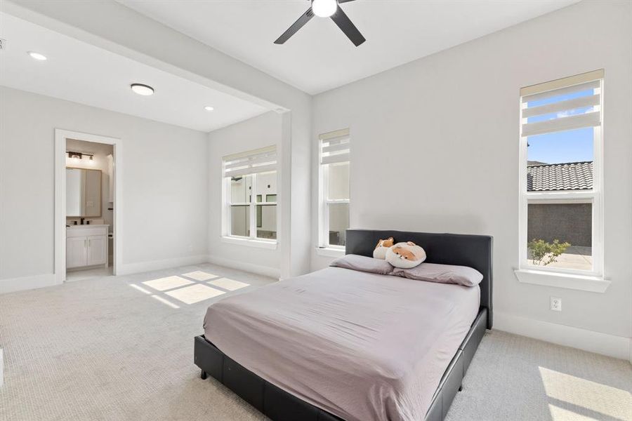Bedroom featuring carpet floors, ensuite bathroom, ceiling fan, and recessed lighting