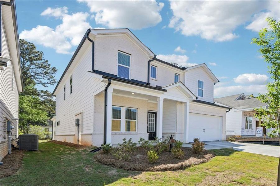 Front exterior of a new home in Martin Springs - Estate Series, Lawrenceville, GA, highlighting curb appeal (Image 25). Front exterior of a new home in Martin Springs - Estate Series, Lawrenceville, GA, highlighting curb appeal (Image 25).