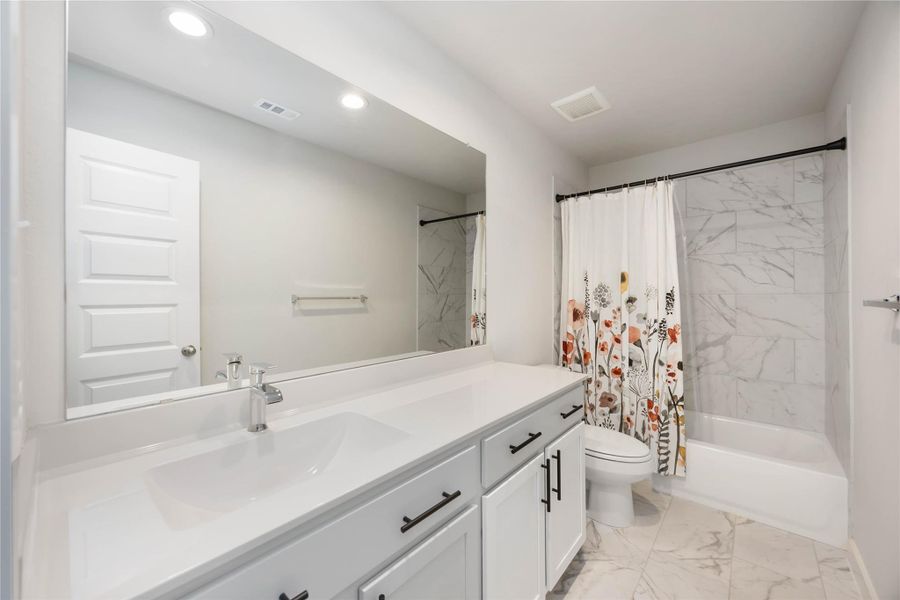 Full bath upstairs with dual sinks and a tub/shower combo. Full bath upstairs with dual sinks and a tub/shower combo.