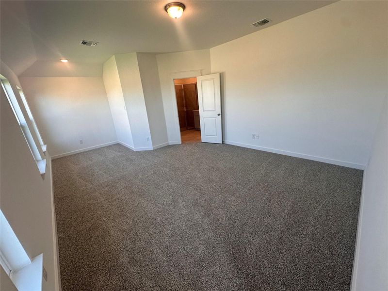 Empty room with carpet and baseboards Empty room with carpet and baseboards
