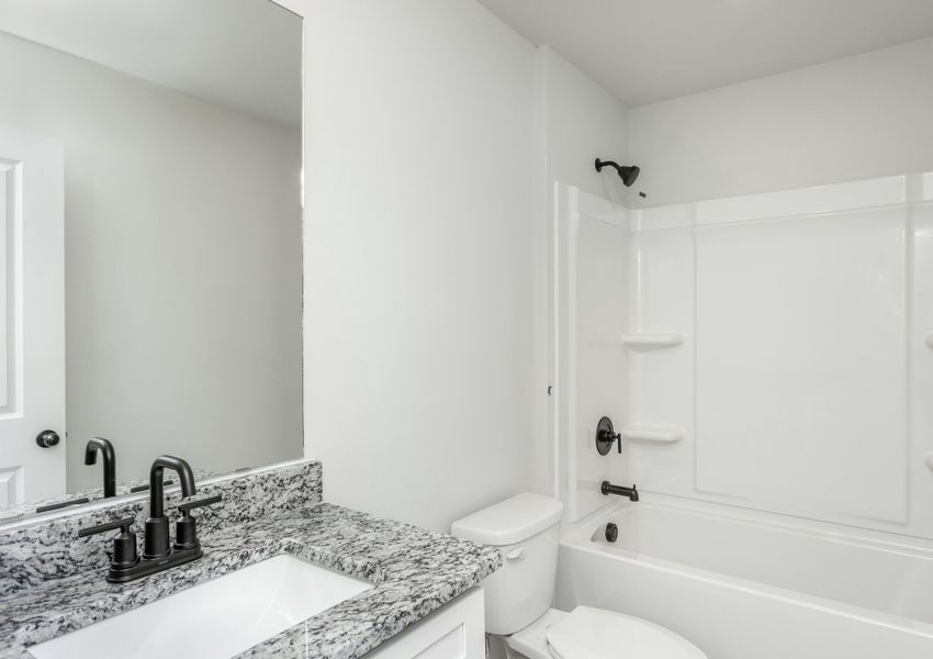 The secondary bathroom has a large soaking tub.