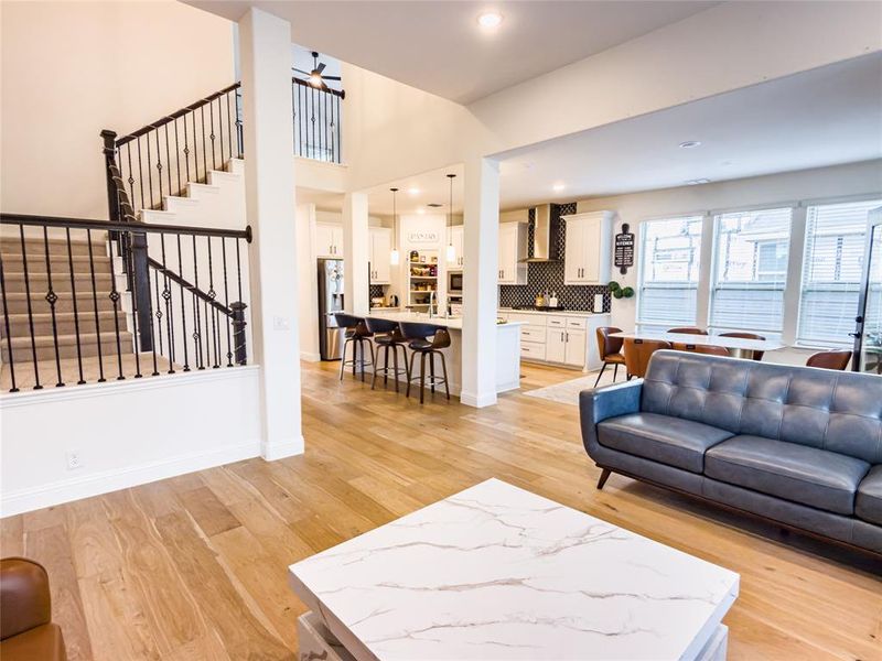 Living room featuring light wood-style floors, a ceiling fan, and recessed lighting