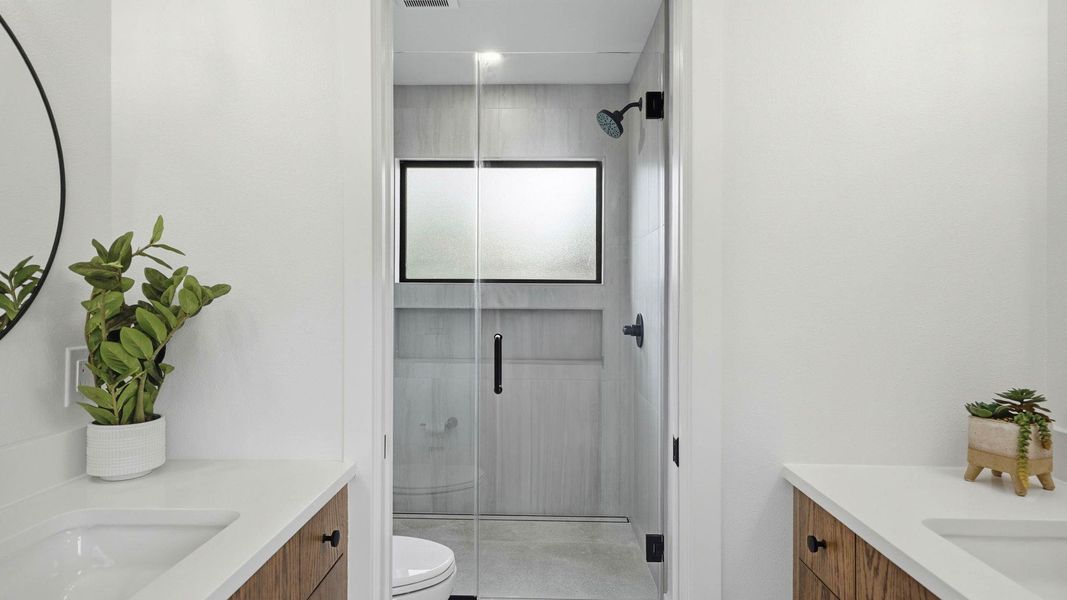 Bathroom featuring vanity and a shower stall