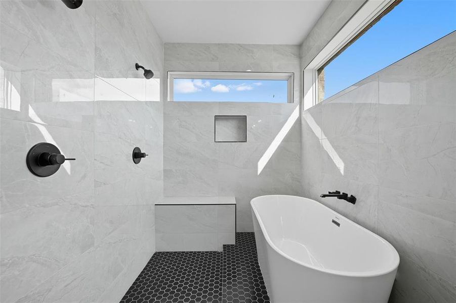 Full bathroom featuring tile walls, a freestanding tub, tiled shower, and tile patterned flooring Full bathroom featuring tile walls, a freestanding tub, tiled shower, and tile patterned flooring