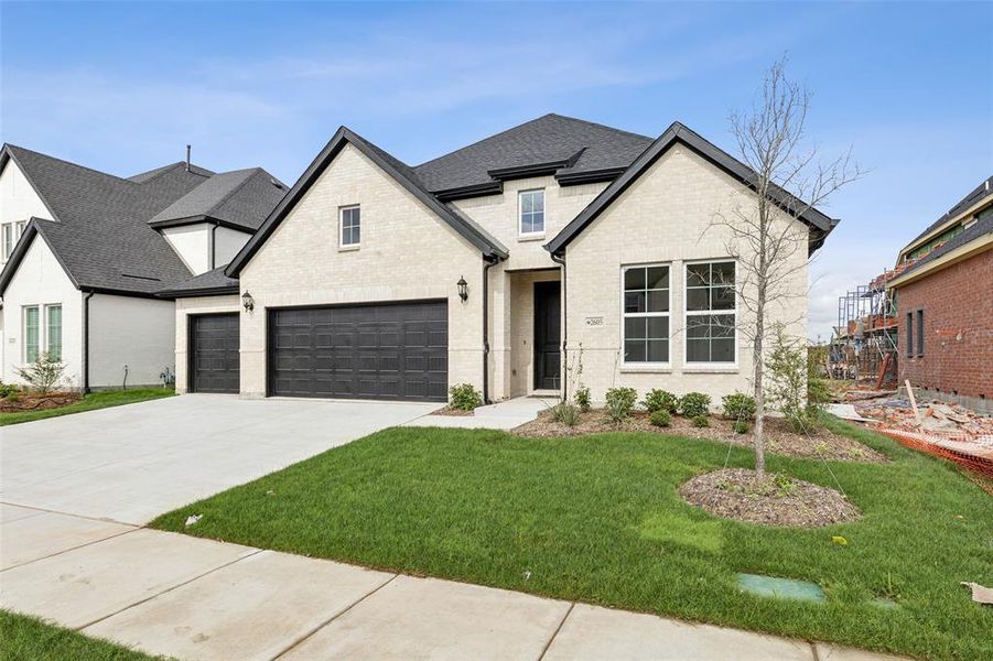 offering light colored brick with dark trim, this dream home has tons of curb appeal!