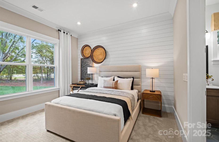 Private first floor guest suite has private bathroom with tile walk-in shower and separate walk-in closet.  Representative photo