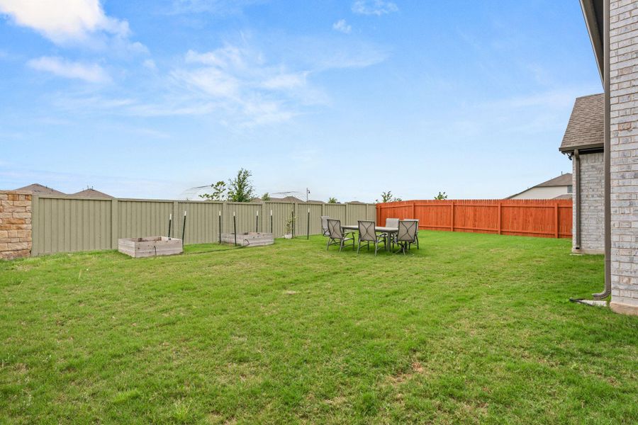 A spacious backyard with vibrant green grass, perfect for outdoor living. A spacious backyard with vibrant green grass, perfect for outdoor living.