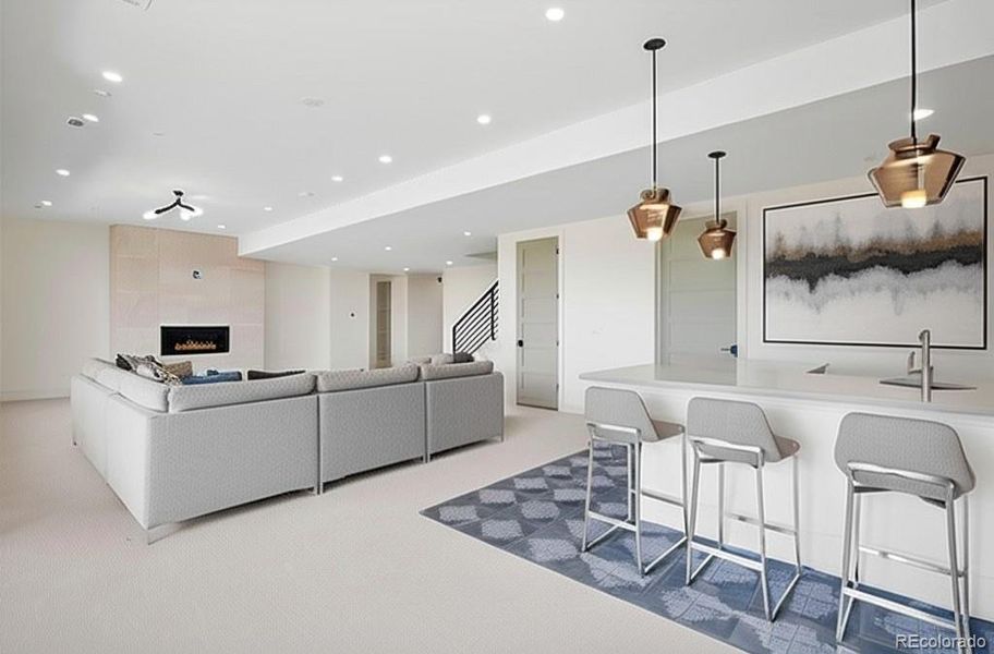 Lower level rec room with wet bar. *This photo has been virtually staged
