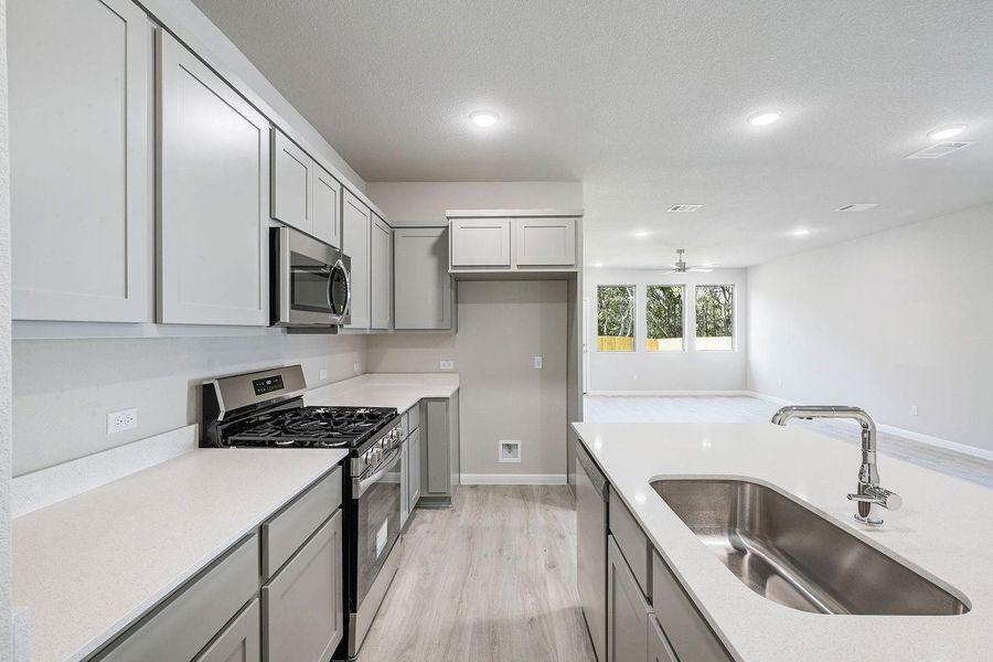 Kitchen in the Willow home plan by Trophy Signature Homes – REPRESENTATIVE PHOTO