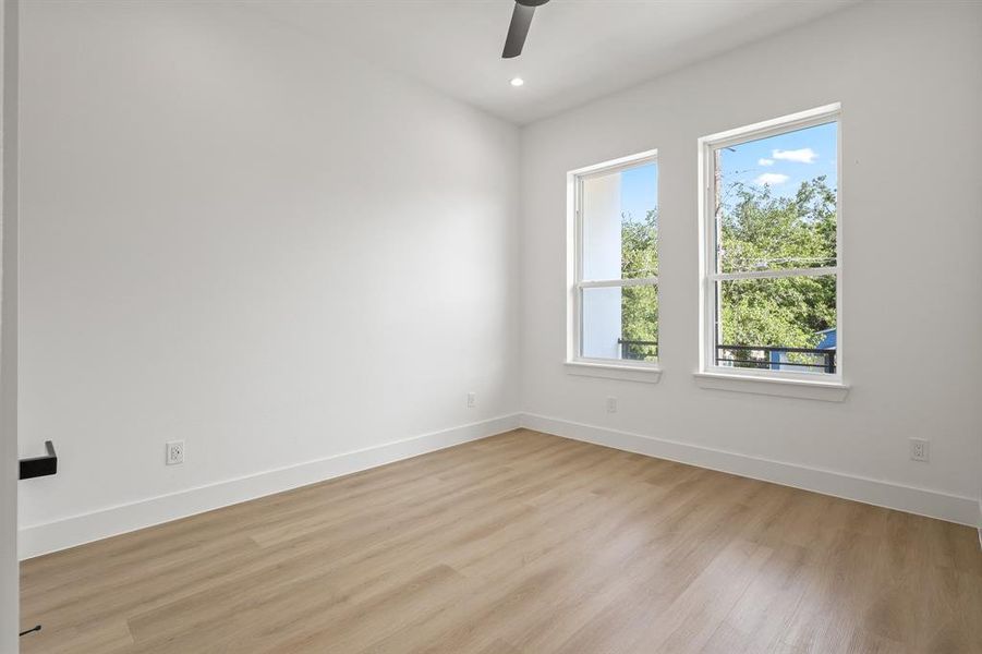 Empty room with a wealth of natural light and light hardwood / wood-style floors