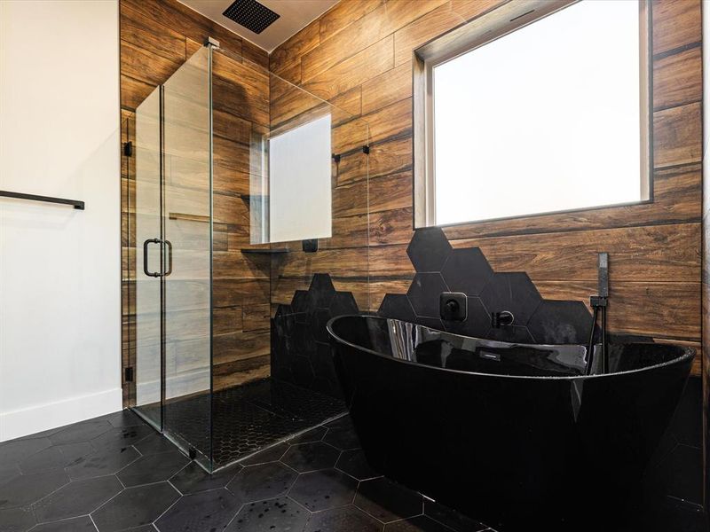 Bathroom with a freestanding tub and a shower stall