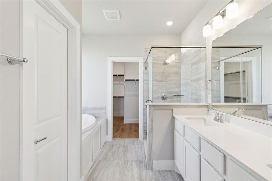 Bathroom featuring plus walk in shower and vanity