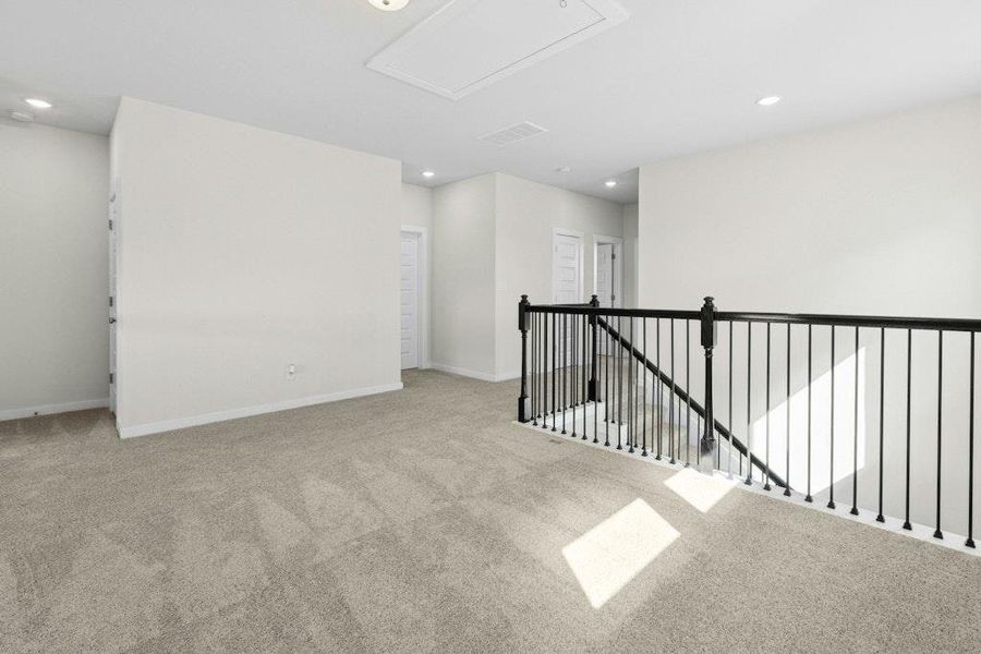 Spare room featuring light carpet and recessed lighting