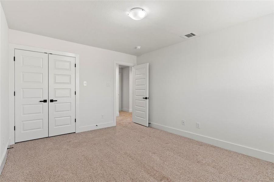 Unfurnished bedroom featuring carpet floors and a closet Unfurnished bedroom featuring carpet floors and a closet