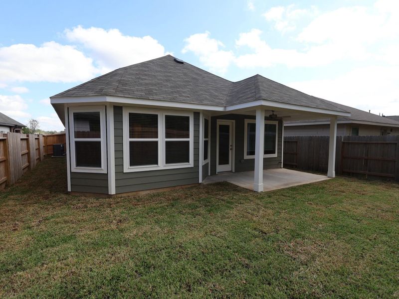 Exterior details and patio area of a home in Pinewood at Grand Texas, New Caney (Image 1).