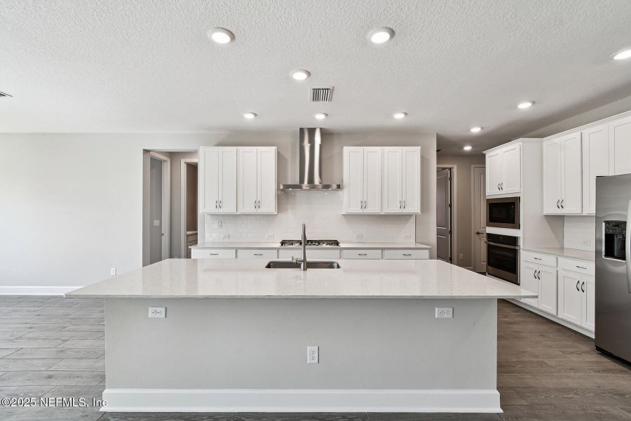 Furnished interior view inside a new home in Tributary 70', Yulee (Image 7).