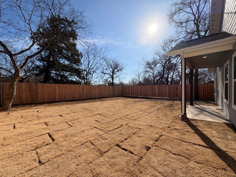 Fenced backyard featuring a patio area Fenced backyard featuring a patio area