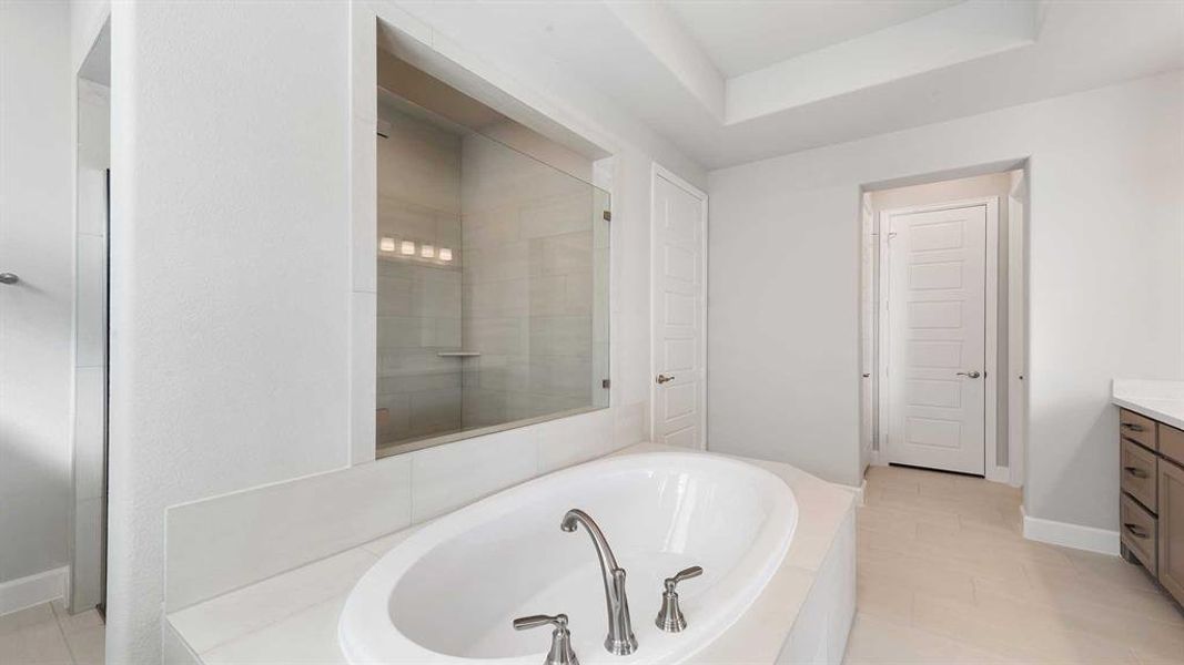 Bathroom featuring vanity, tile patterned floors, and separate shower and tub