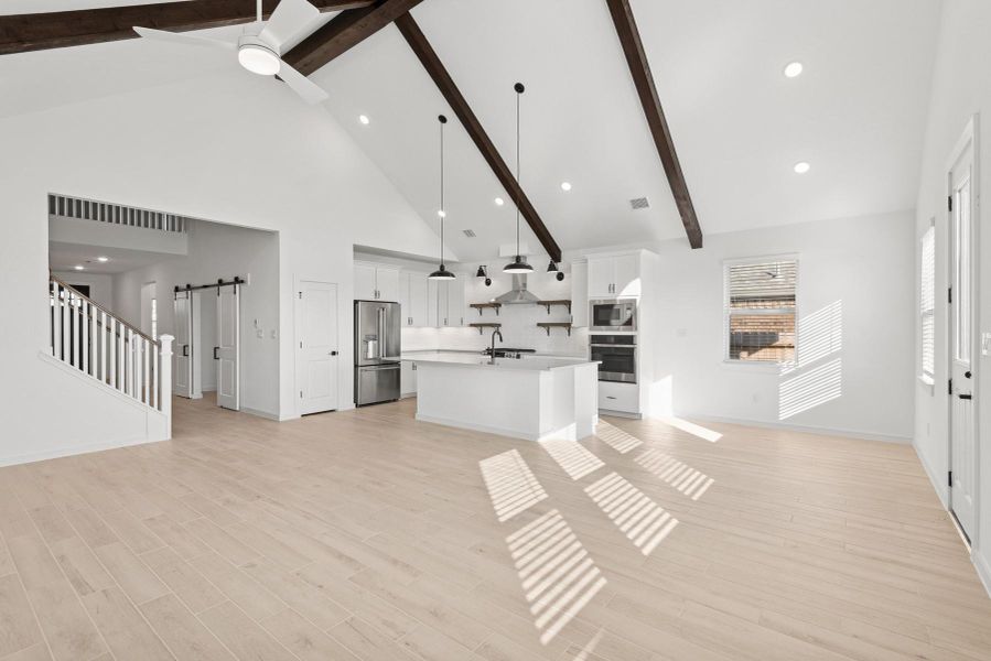 Open living space with stained beams on the vaulted ceiling Open living space with stained beams on the vaulted ceiling
