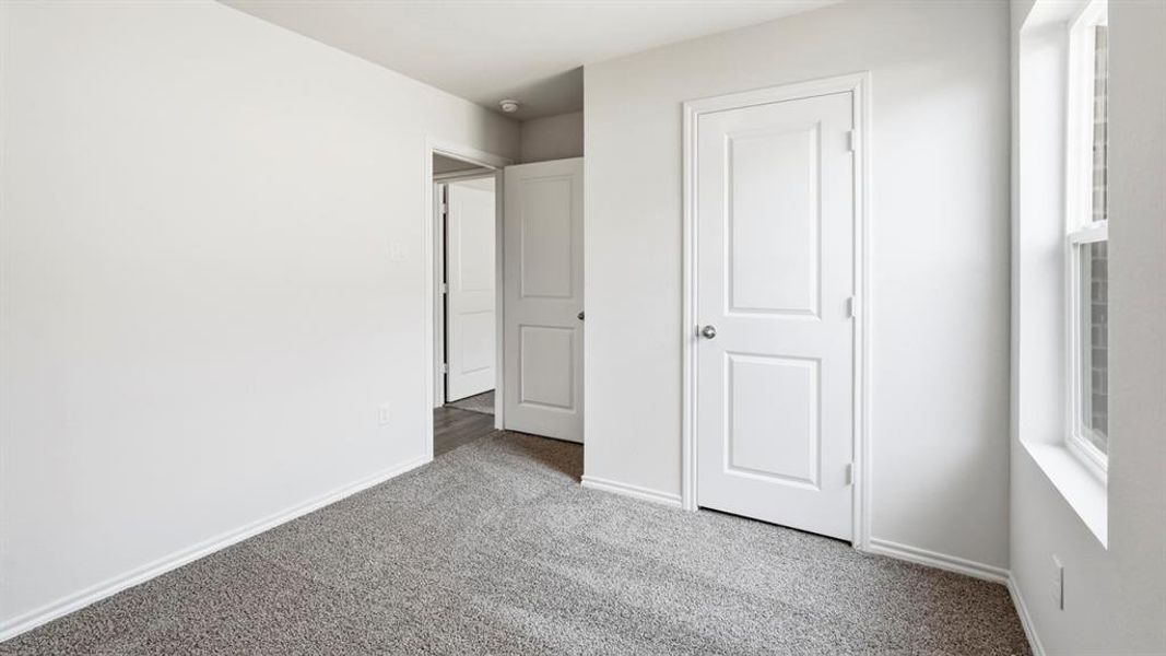 Unfurnished bedroom featuring carpet floors and baseboards Unfurnished bedroom featuring carpet floors and baseboards
