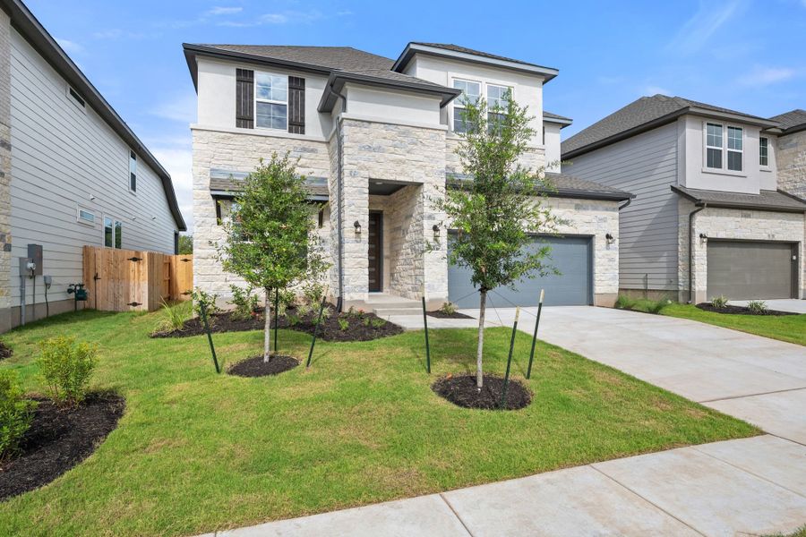 Front exterior of a new home in Lagos Reserve, Manor, TX, highlighting curb appeal (Image 2). Front exterior of a new home in Lagos Reserve, Manor, TX, highlighting curb appeal (Image 2).