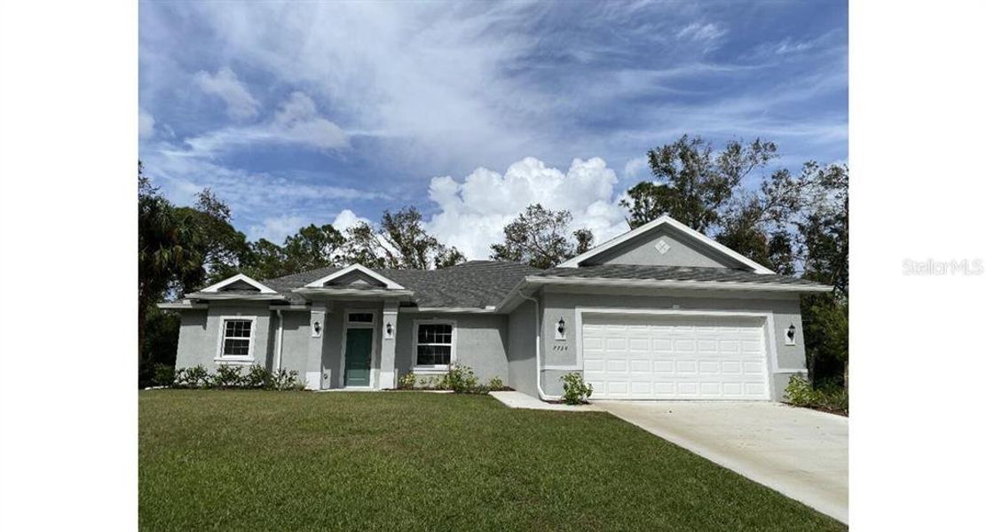 Front exterior of a new home in , North Port, FL, highlighting curb appeal (Image 1). Front exterior of a new home in , North Port, FL, highlighting curb appeal (Image 1).