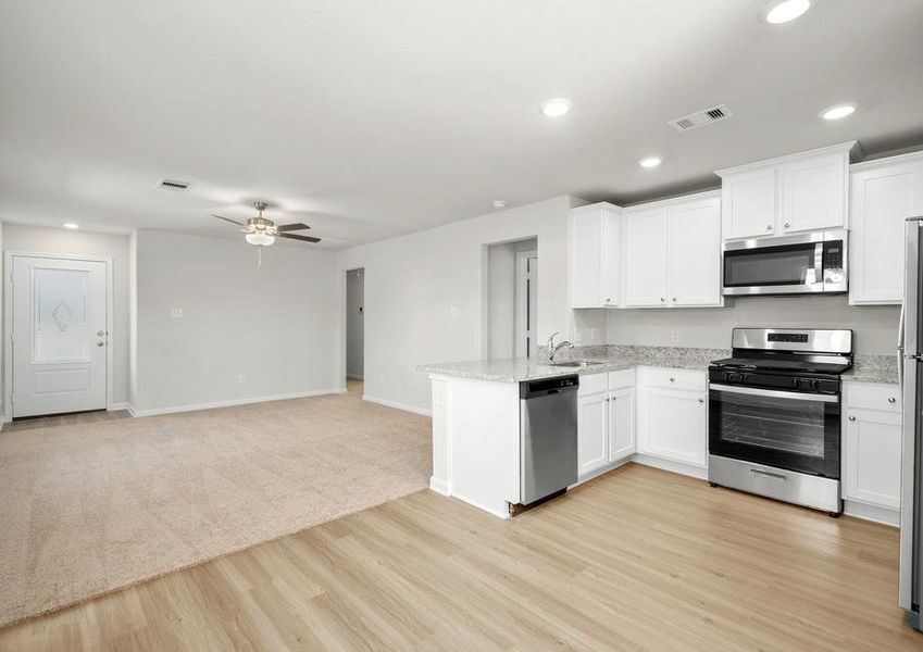 The open layout has the kitchen and dining room open to the family room.