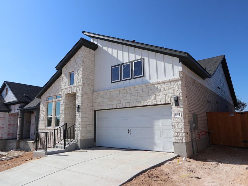 Front exterior of a new home in Heritage, Dripping Springs, TX, highlighting curb appeal (Image 1). Front exterior of a new home in Heritage, Dripping Springs, TX, highlighting curb appeal (Image 1).