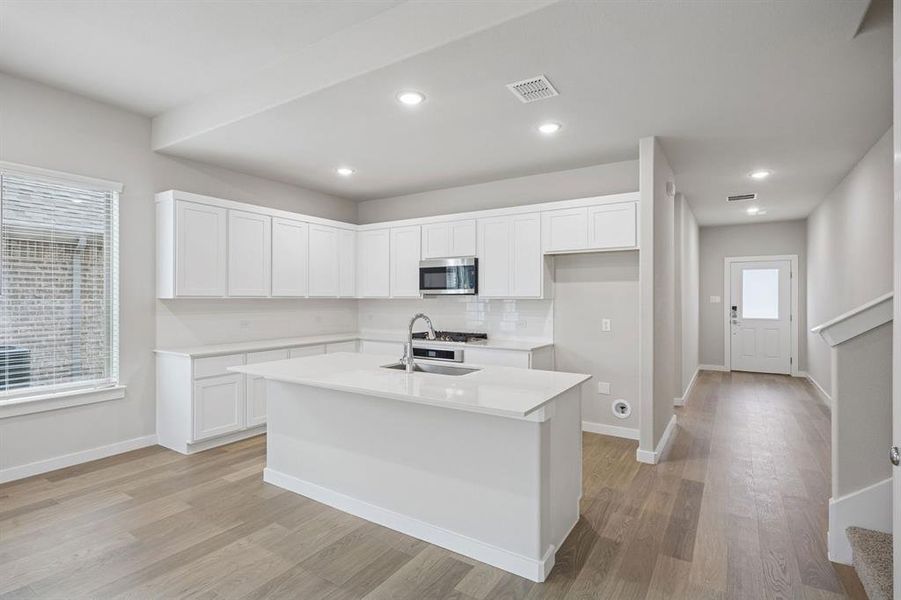 Kitchen in the Stanley II home plan by Trophy Signature Homes – REPRESENTATIVE PHOTO